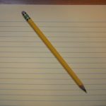 Image of a pencil and yellow legal pad