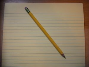 Image of a pencil and yellow legal pad