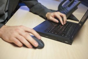 Image of a man using a laptop