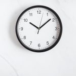 Black wall clock on a table