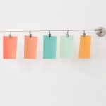 Color pieces of paper hanging from a line