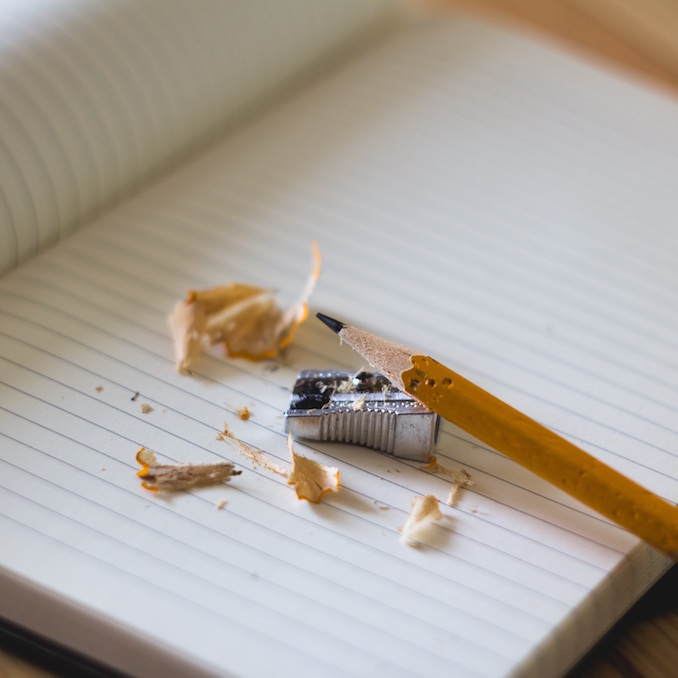 Pencil and sharpener on an open notebook