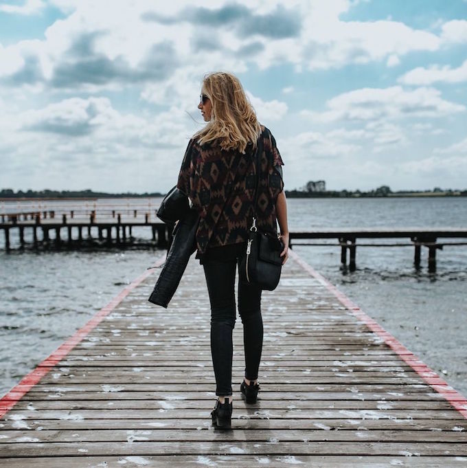 Woman walking on a dock on the water