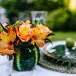 Bouquet of orange flowers at an outdoor table setting