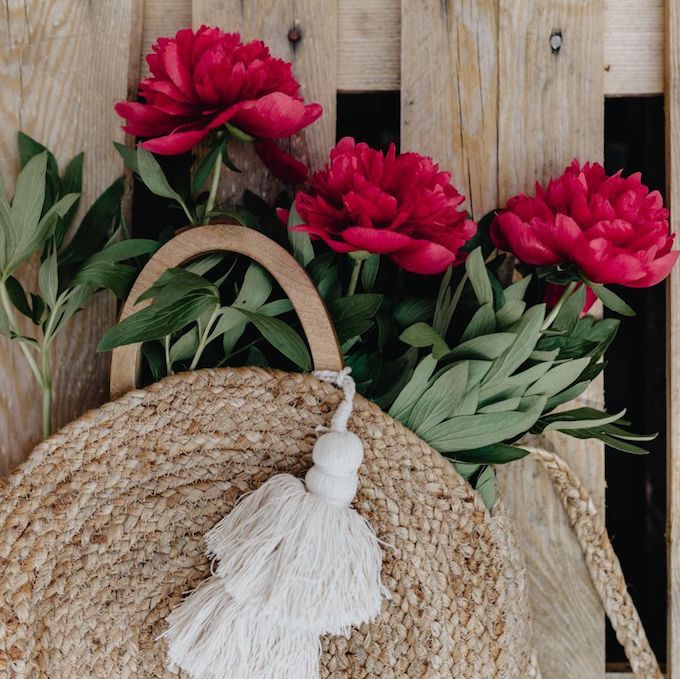 Basket with flowers near a fence