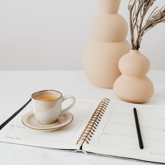 Tea cup and planner on a table