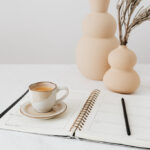 Cup of coffee and a planner on a table